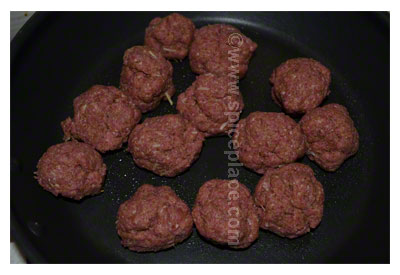 Uncooked Spatini Beef Meatballs in pan